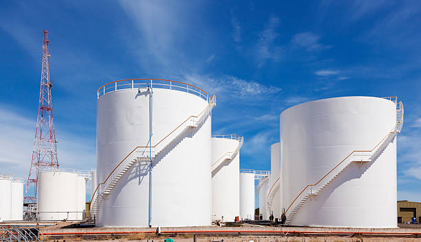 large tank farm construction site with multiple white storage tanks